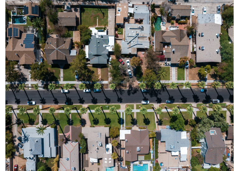 Aerial view of a residential neighborhood in Dothan, Alabama, showcasing tree-lined streets, single-family homes, and well-maintained yards.